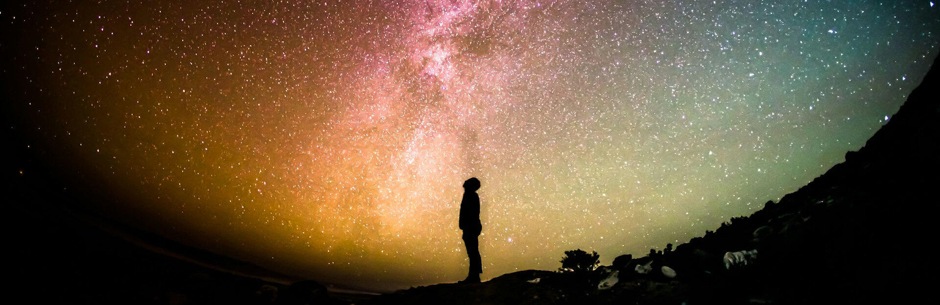 finding togetherness in our brilliance silhouette of person looking up at a starry sky