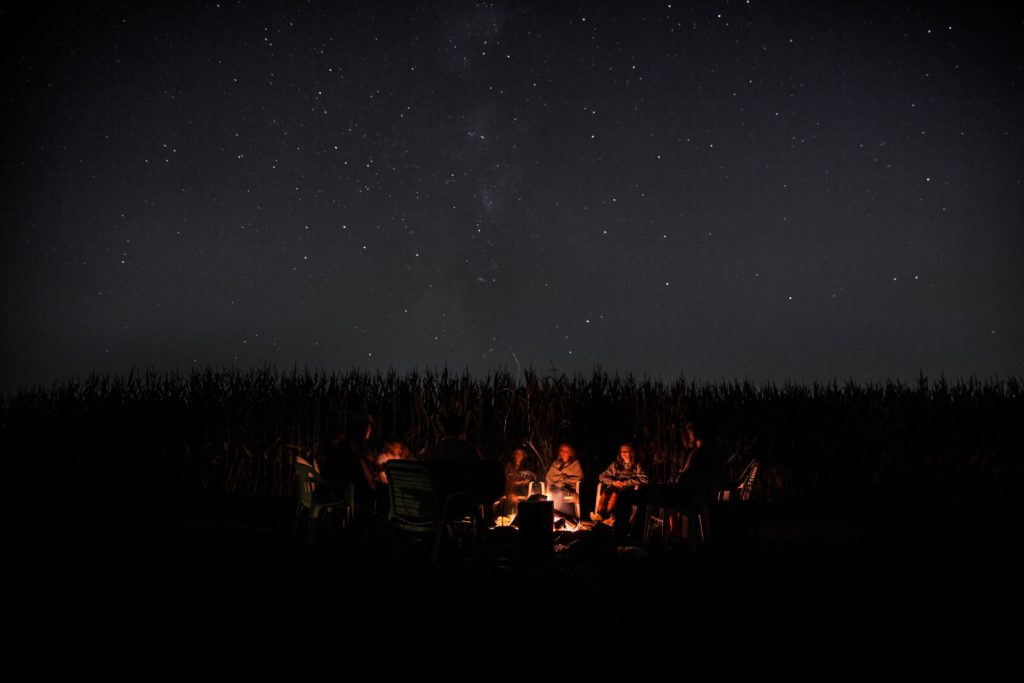 people having a bonfire under stars
