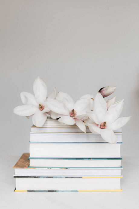 magnolia on a stack of books